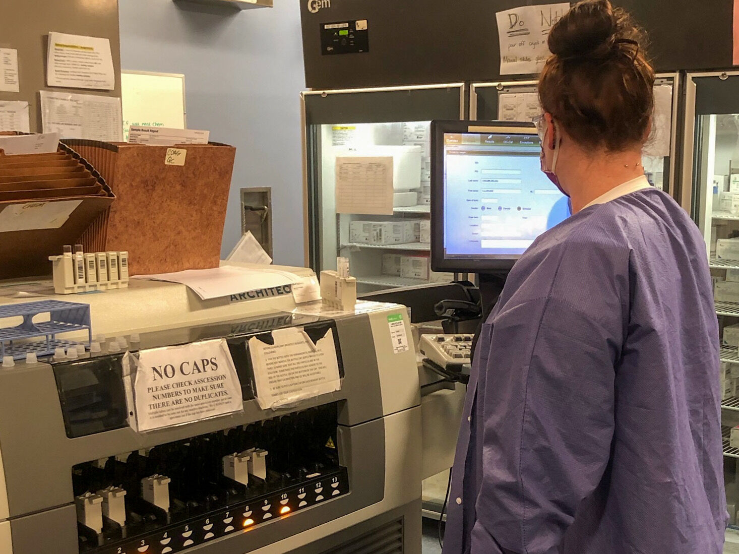 A nurse is standing near the machine used to process antibody test samples at Firsthler Moore Regional Hospital in Pinehurst.